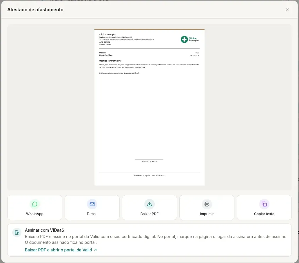 Janela Atestado de afastamento no computador, com a página do PDF com o cabeçalho da Clínica Exemplo, os botões WhatsApp, E-mail, Baixar PDF, Imprimir e Copiar texto e o cartão Assinar com VIDaaS